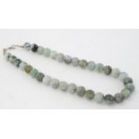 Jade / Jadite / Nephrite : a Chinese green spherical cold stone necklace, 22” long.