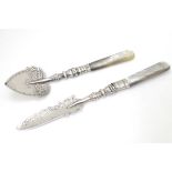 A silver jam / preserve spoon with silver handle together with a matching butter knife.