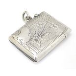 A silver vesta case with engraved decoration.