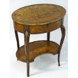 A 19thC French centre table with an oval top and brass mounts,