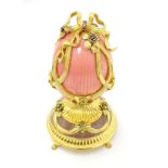 Franklin Mint : A silver gilt model of a Faberge egg ' The Faberge Rose Bouquet ' with pink enamel