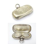 A silver sovereign case / carrier of oblong form opening to reveal provision for sovereign and half