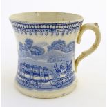 A 19thC blue and white tankard decorated with a train 'JACO' in a landscape. Approx. 4 ½” high.