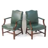 A pair of Gainsborough style open armchairs with leather upholstery and carved arms,