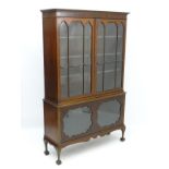 A mid 20thC mahogany glazed bookcase,