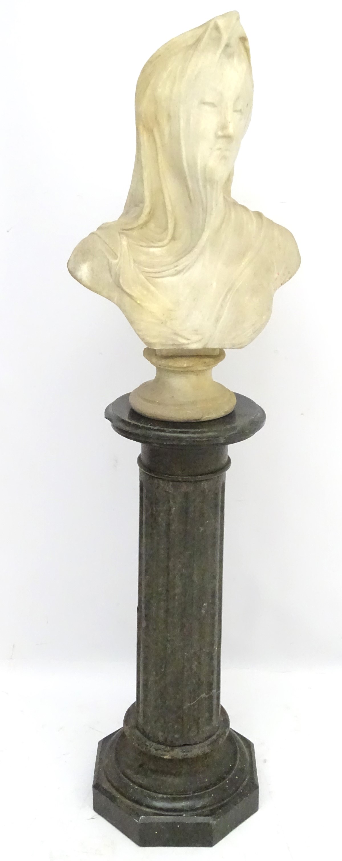 A 19thC fluted granite column and base surmounted by a white marble bust of a veiled woman with