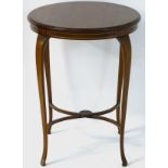 An early 20thC Sheraton revival occasional table with a circular top and having decorative