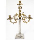 A three branch upcycled candelabra with a silver plated gadrooned base with a gilt metal top.