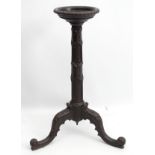 An early 20thC mahogany jardiniere stand with carved frame.