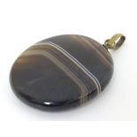 A banded agate pendant approx 1 1/2" long CONDITION: Please Note - we do not make