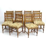 A set of 8 Bruce James Talbert designed oak dining chairs,