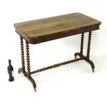 A mid / late 19thC rosewood table with turned supports united by a turned stretcher and raised on