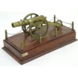Militaria: a late 20thC model cannon, of brass construction affixed to a stepped mahogany plinth.