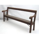 A 19thC church pew with scrolled arms and of peg jointed construction. 84” long.