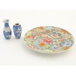 An Oriental plate decorated with stylised flowers, with a scrolling floral design to reverse.