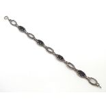 A silver bracelet set with onyx and marcasite CONDITION: Please Note - we do not