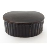 A Georgian papier mache scallop shaped hinged snuff box with a reeded edge. 2 1/4” wide.
