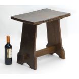 A 18thC and later oak stool with rectangular top above a trestle base.