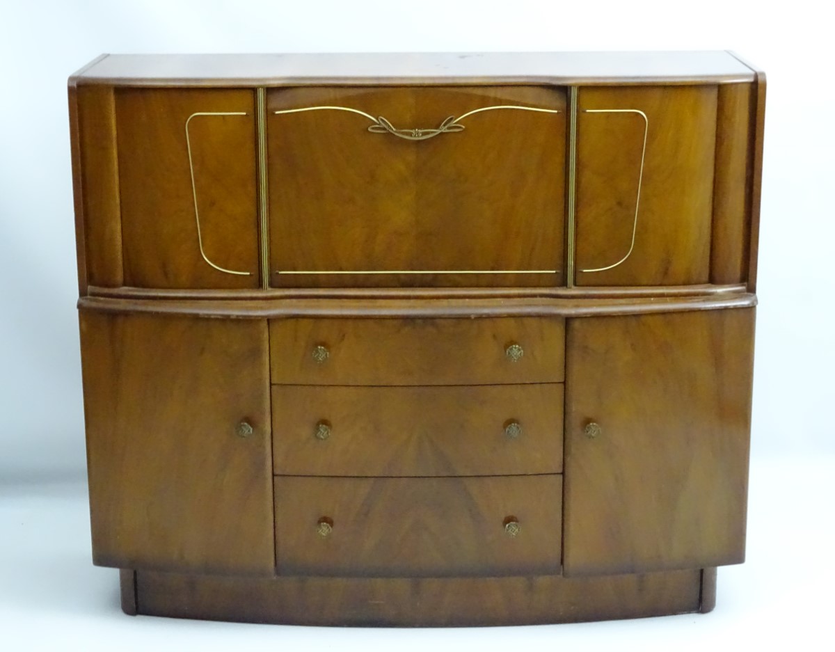 A 1930’s walnut cocktail cabinet, the top opening to reveal fitted shelves and a mirrored back. - Image 9 of 12