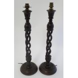 A pair of mid 20thC Walnut triple open twist lampstands with circular bases ,
