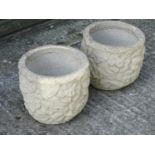 A pair of reconstituted stone large 20 thC planters having floral and foliate relief decoration