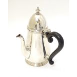 A silver chocolate pot with ebonised handle hallmarked London 1926 maker Goldsmiths & Silversmiths