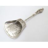 A Continental white metal caddy spoon depicting figures dancing. German .