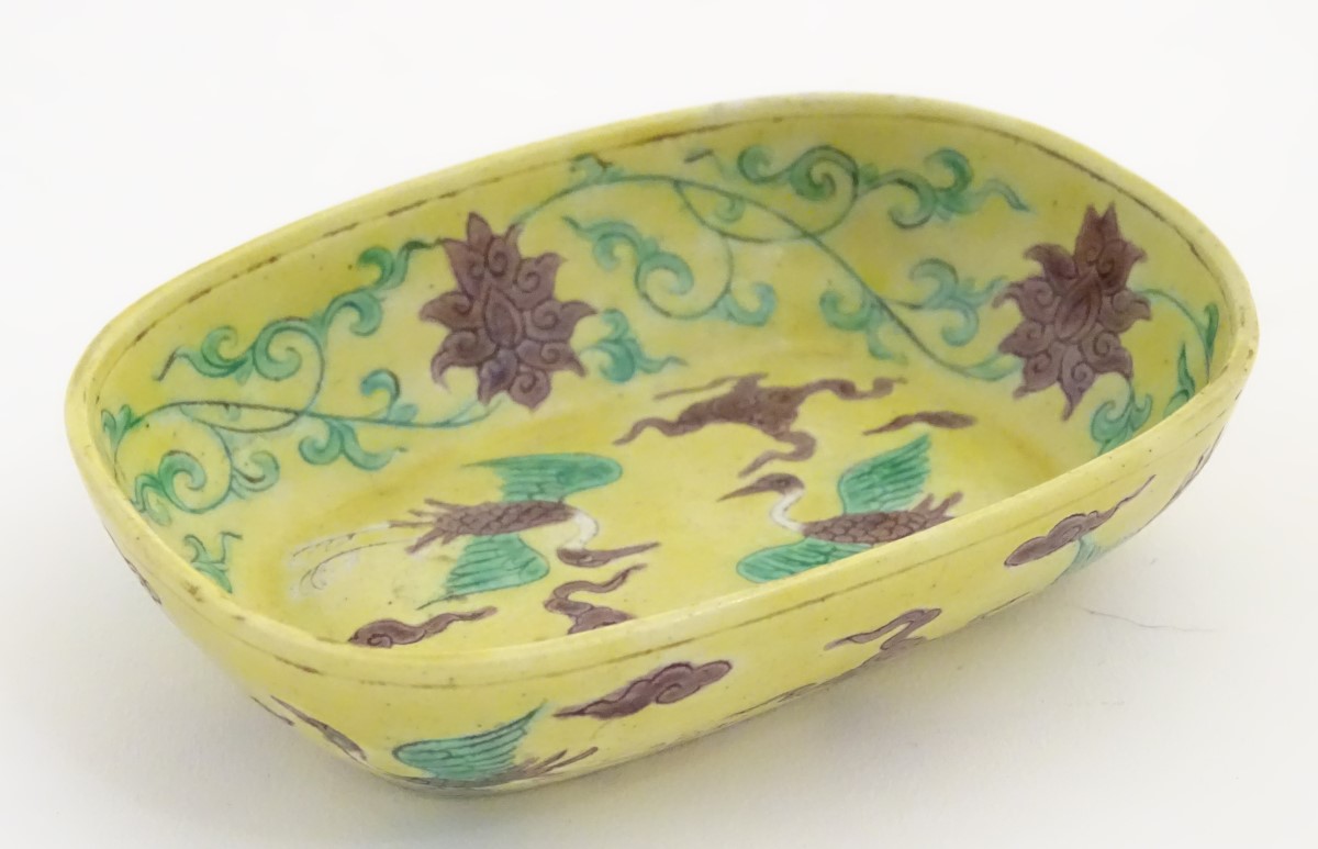 A small Chinese dish decorated with stylised birds, clouds and flowers. Character marks to base.