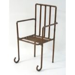 A late 20thC open armchair formed from copper piping.