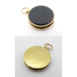 An unsensual gold pendant locket set with Spade Guinea to one side and bloodstone seal to other.