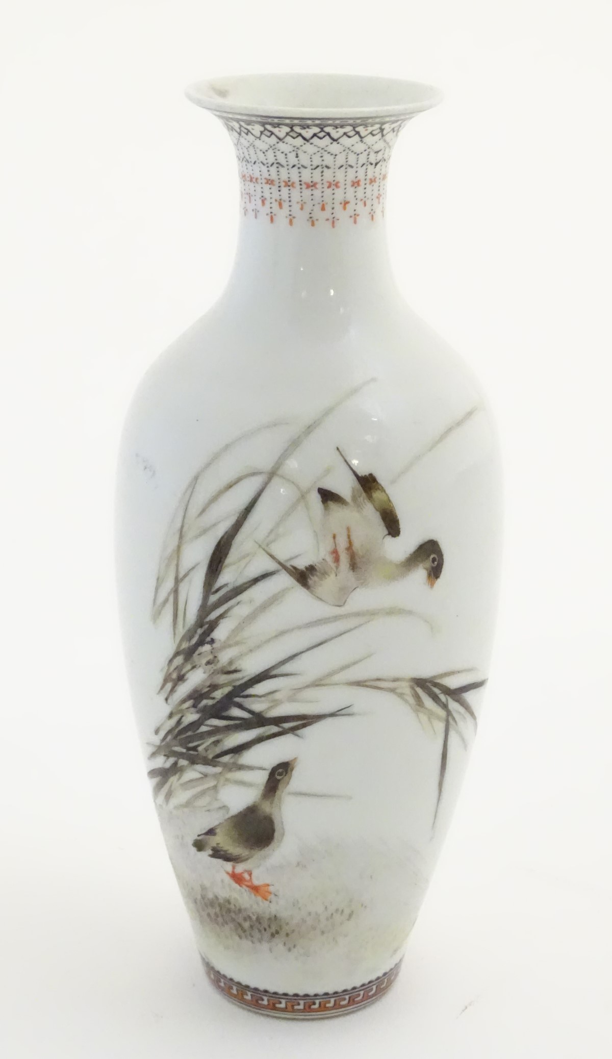 A small Oriental baluster vase, decorated with wader birds in reeds,
