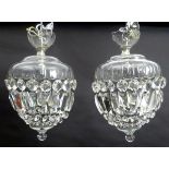 A pair of crystal facet cut glass electric and chrome pendant light fittings,