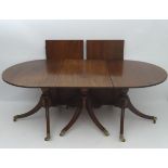 An early 20thC mahogany triple pedestal dining table,