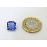 Unmounted stone: A blue cushion cut tanzanite, approx 8.