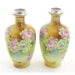 A pair of small Japanese baluster vases with hand painted floral decoration,