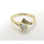 An opal ring set with central opal flaked by white stones.