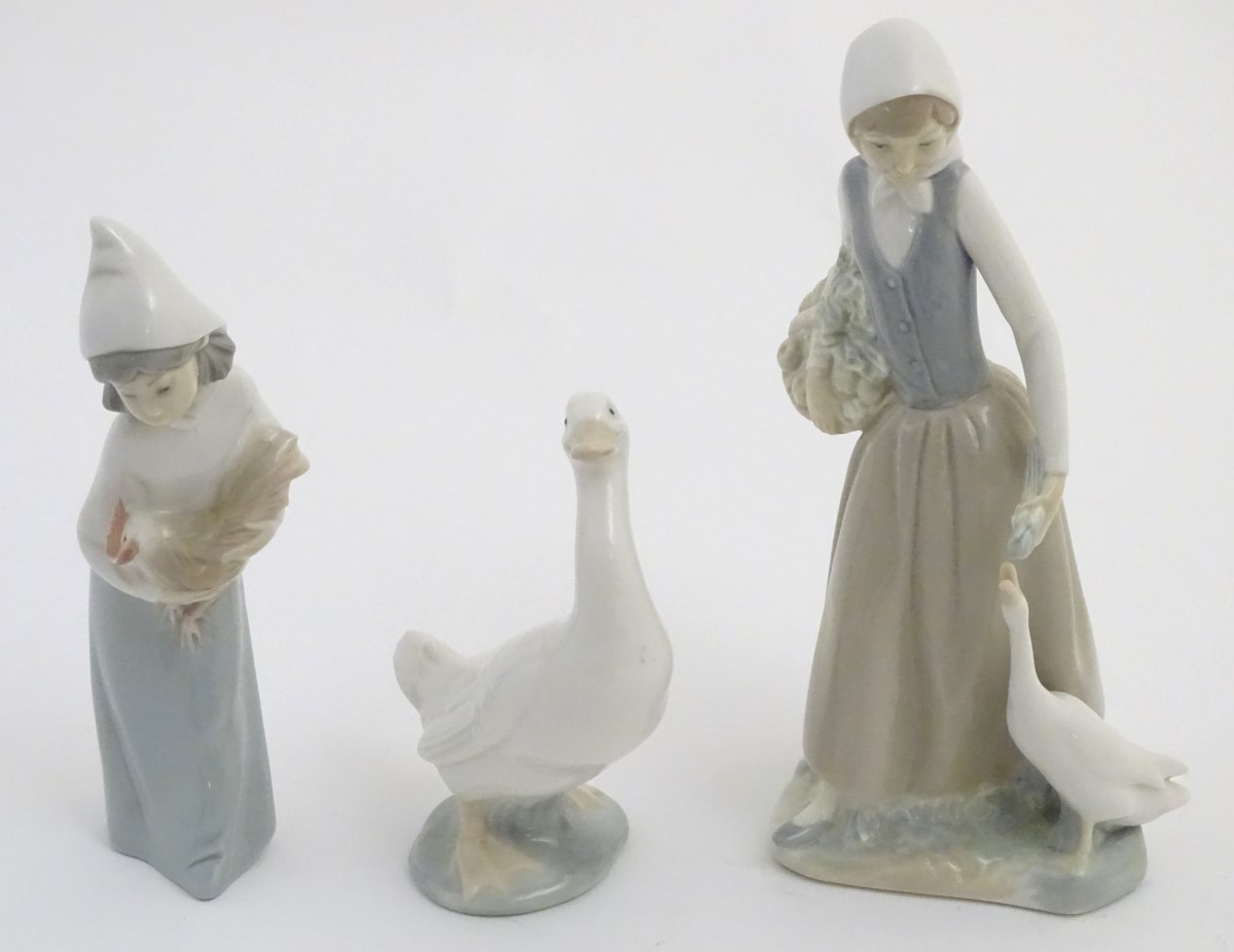 A quantity of Lladro and Nao figures, to include two Lladro penguins and girl holding a chicken, - Image 5 of 11