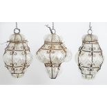 Three pendant Islamic electrified pendant steel framed clear glass lamps, each with hinged tops,