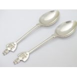 A pair of commemorative silver teaspoons, the handles surmounted by castles titled 1614.