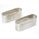 A pair of silver napkin rings with engine turned decoration hallmarked Birmingham 1950 maker John