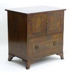 An early 19thC mahogany side cabinet with flame mahogany veneered doors and drawer,