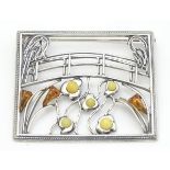 A silver brooch inspired by the work of Claude Monet set with amber detail. 2” wide.