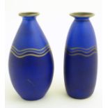 Two blue studio pottery two-tone vases decorated with three gilt undulating bands,