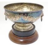 A silver plate pedestal bowl with floral swag decoration and lions mask handle.
