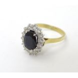 A vintage 18ct gold ring set with central sapphire bordered by 14 diamonds.