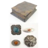 An Arts and Crafts embossed tin box containing 4 antique brooches many with cabachon centres