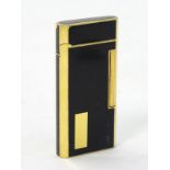 A black lacquer and gold plated Ronson roller cigarette lighter. Approx. 2 1/2" high.