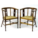 A pair of Edwardian mahogany tub chairs with slatted and pierced back rests,
