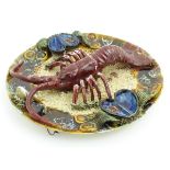 A 20thC Portuguese Palissy style majolica dish with an applied model of a lobster on a bed of sand