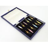 A cased set of 6 Danish silver gilt pickle forks with guilloché enamel decoration to handles